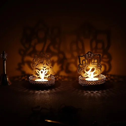 Image of eCraftIndia Set of 2 Golden Metal Lord Ganesha and Goddess Lakshmi Shadow Tea Light Holders - Ideal for Festive Home Dec